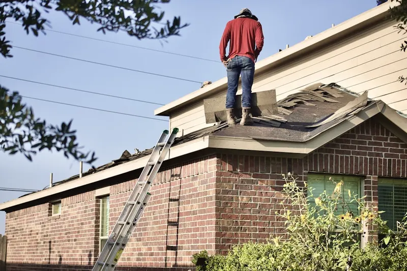 Professional roofer working on a residential roof in Larchmont Hills